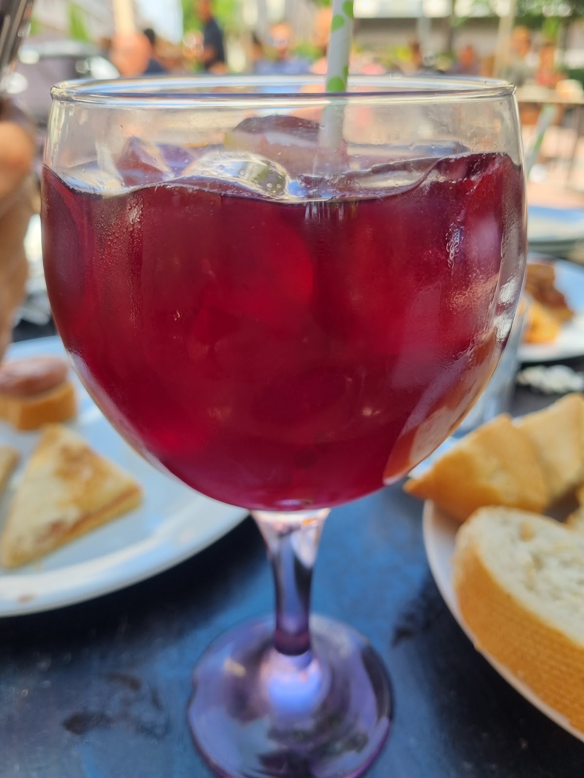 Vaso de sangría casera de color rojo oscuro con hielo